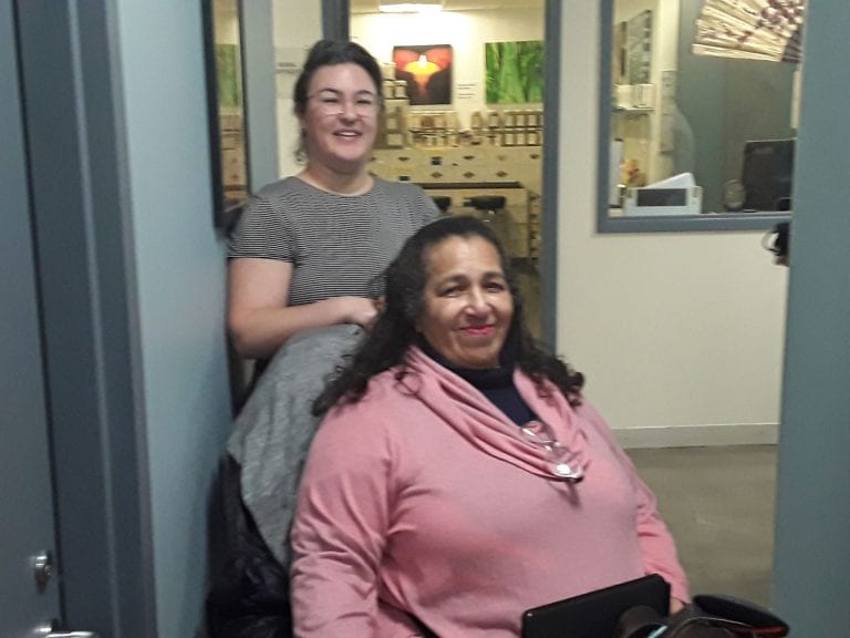 Photo of Elena Tate (rear, Clinical Supervisor) and Ms. Jeanette Jones (seated, client). Photo by Nicolas Arenas.