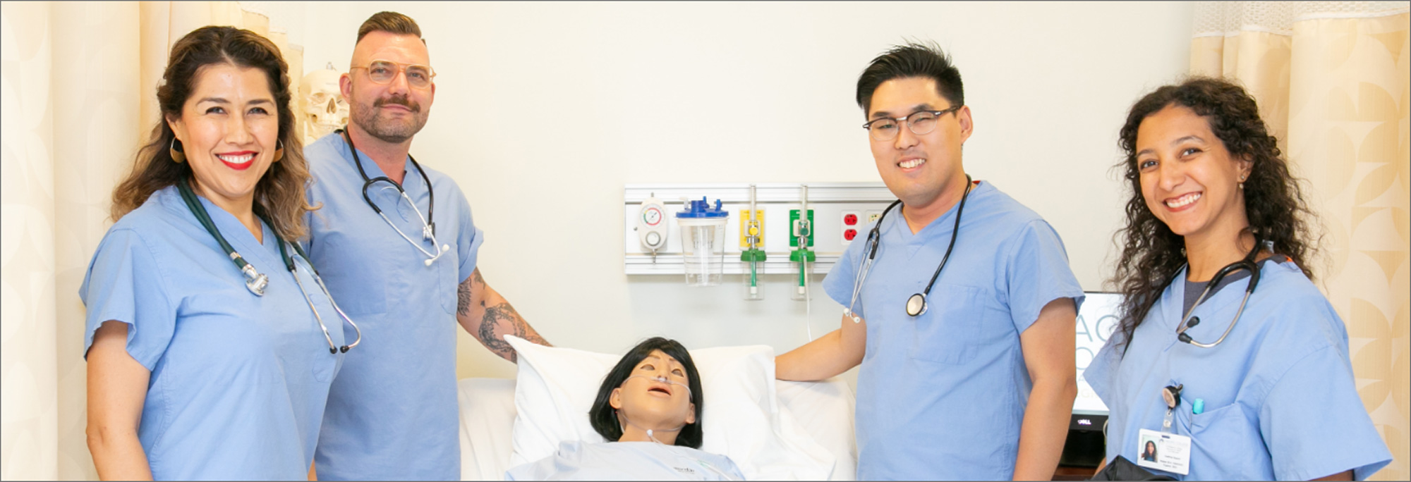 Nurses posing with practice manikin